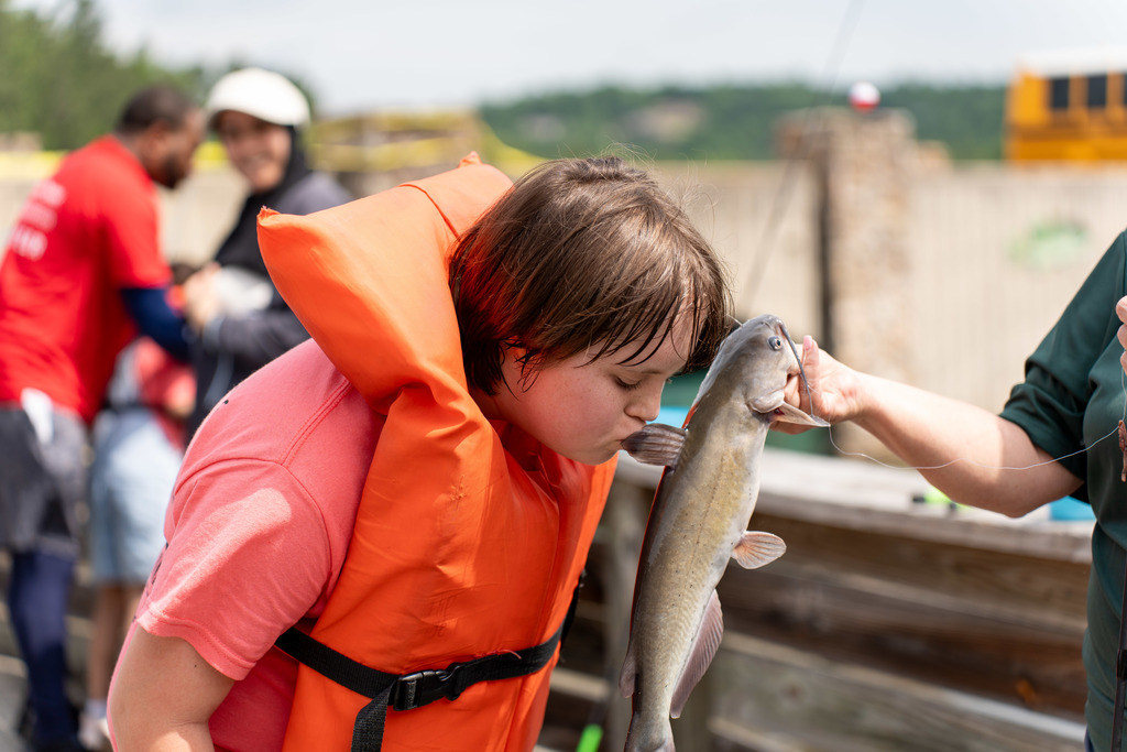 Student with fish at Gone Fishing event.