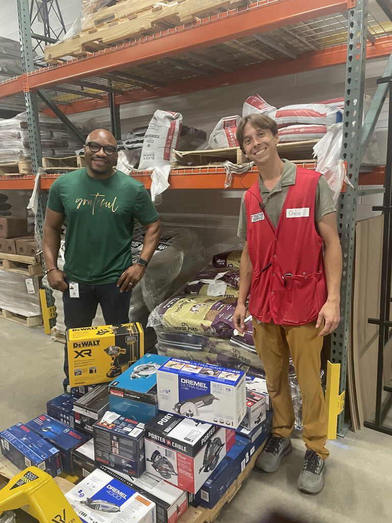 Dr. Epps  &  a Tractor Supply employee with donated supplies and tools