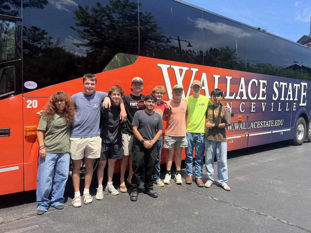 Students standing in front of the bus on their way to SkillsUSA Nationals in Atlanta, Georgia
