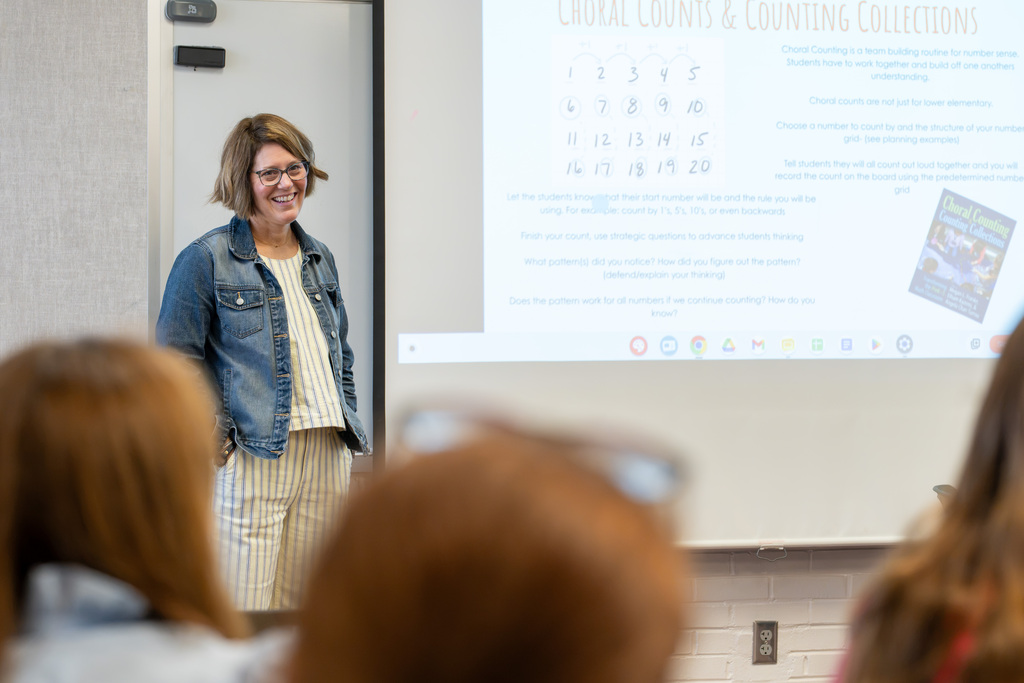 A presenter leads a professional development session using a classroom display while educators follow along.