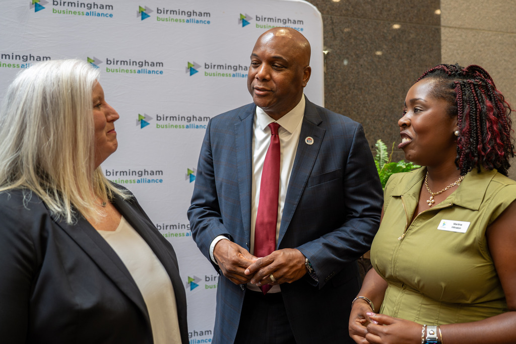Dr. Lewis Brooks speaking to Dr. Sherlene McDonald at Birmingham Business Alliance Luncheon