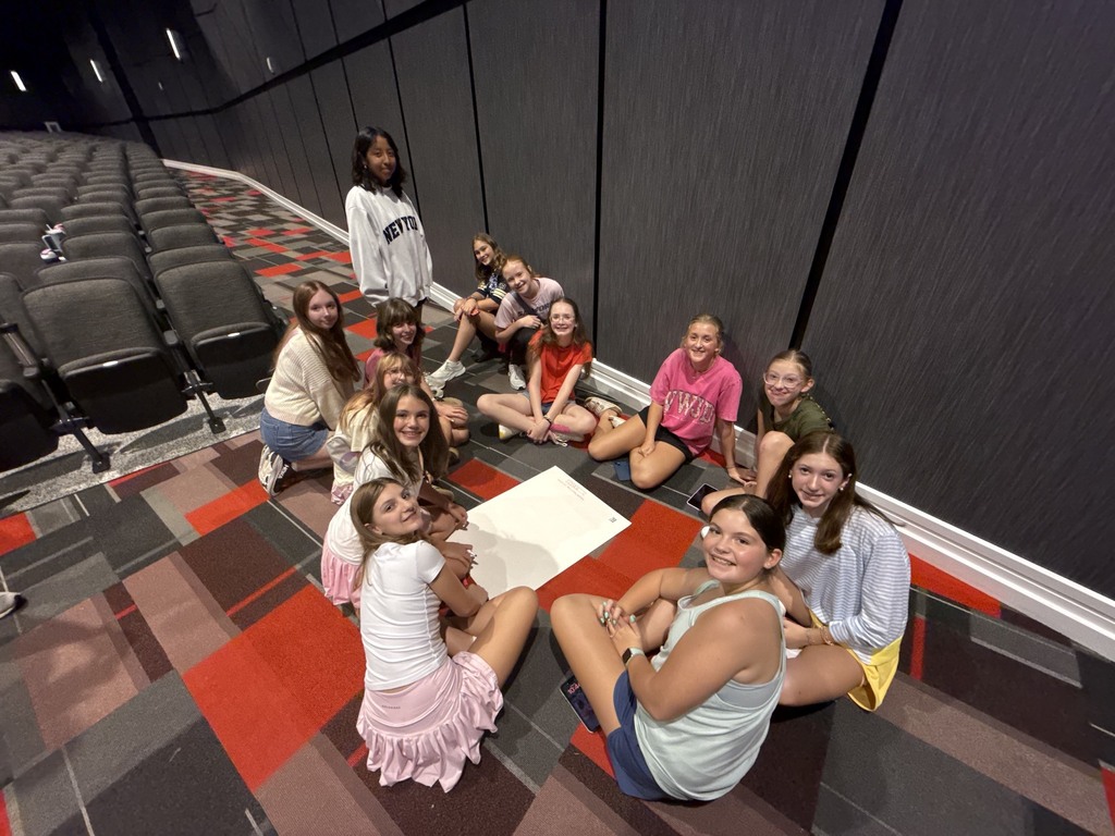 Group photo of the OMMS yearbook staff in a high school auditorium