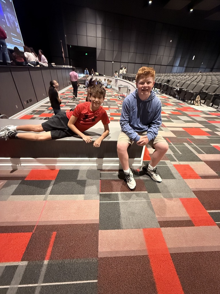 Photo of the OMMS yearbook staff in a high school auditorium