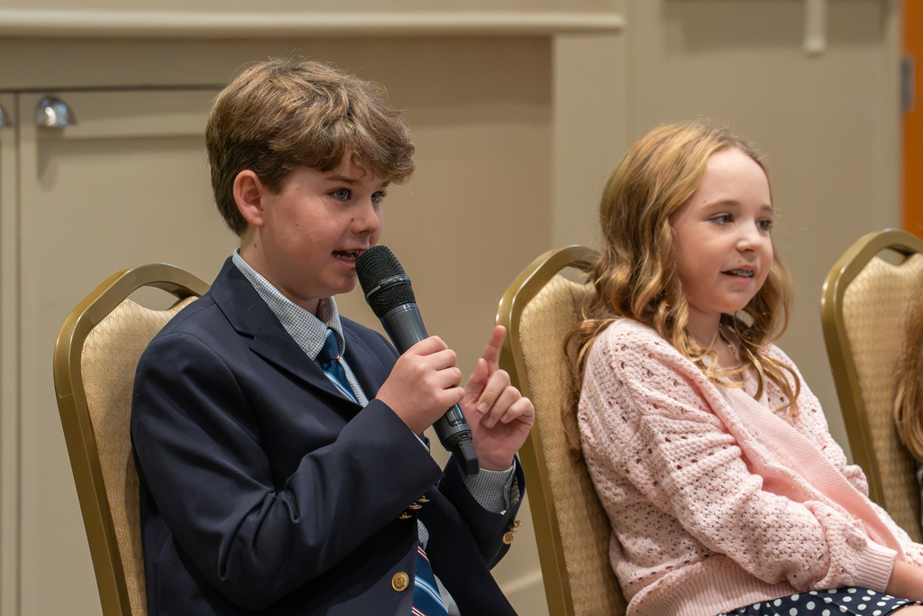 An intermediate student speaks during a panel discussion at State of Our Schools.