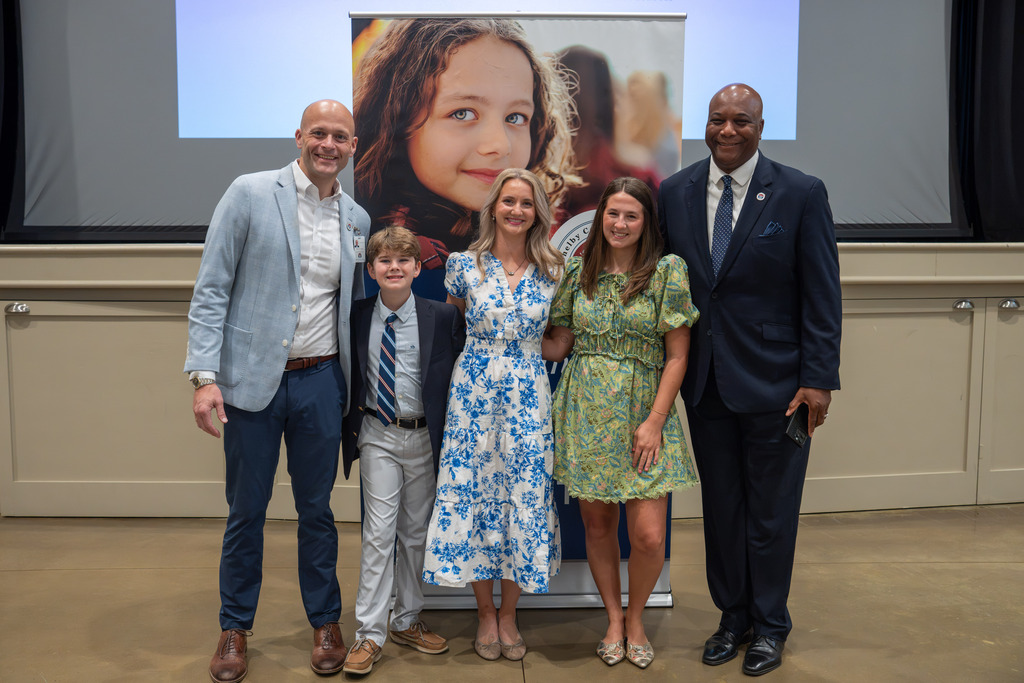 State of Our Schools panelists and district leaders pose together following the event.
