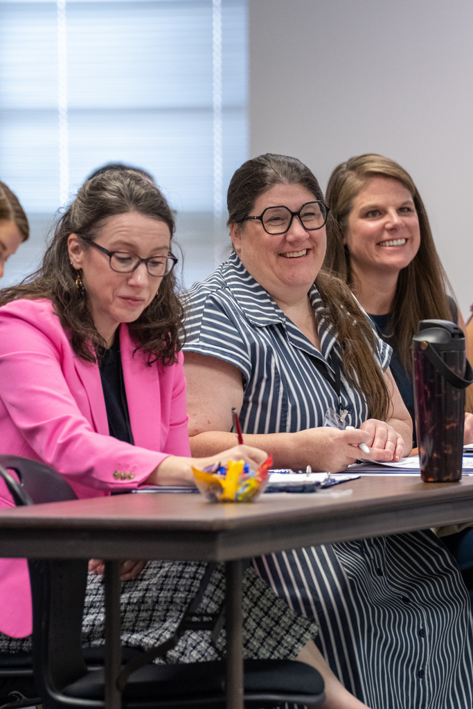 People smiling at a Shelby 101 Meeting