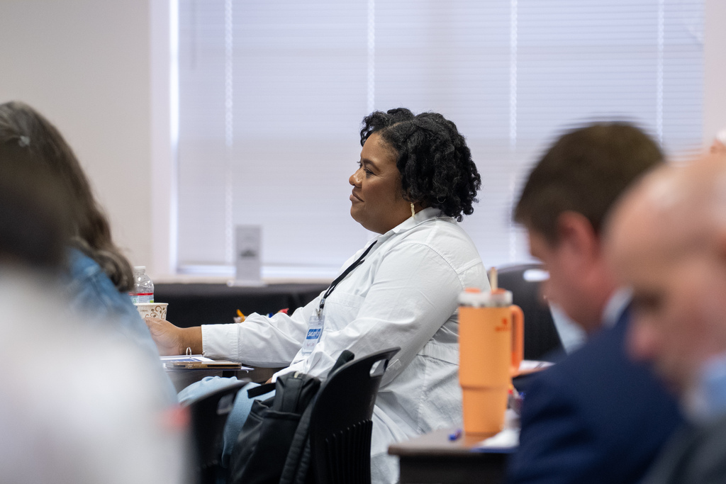 A lady listening at the meeting