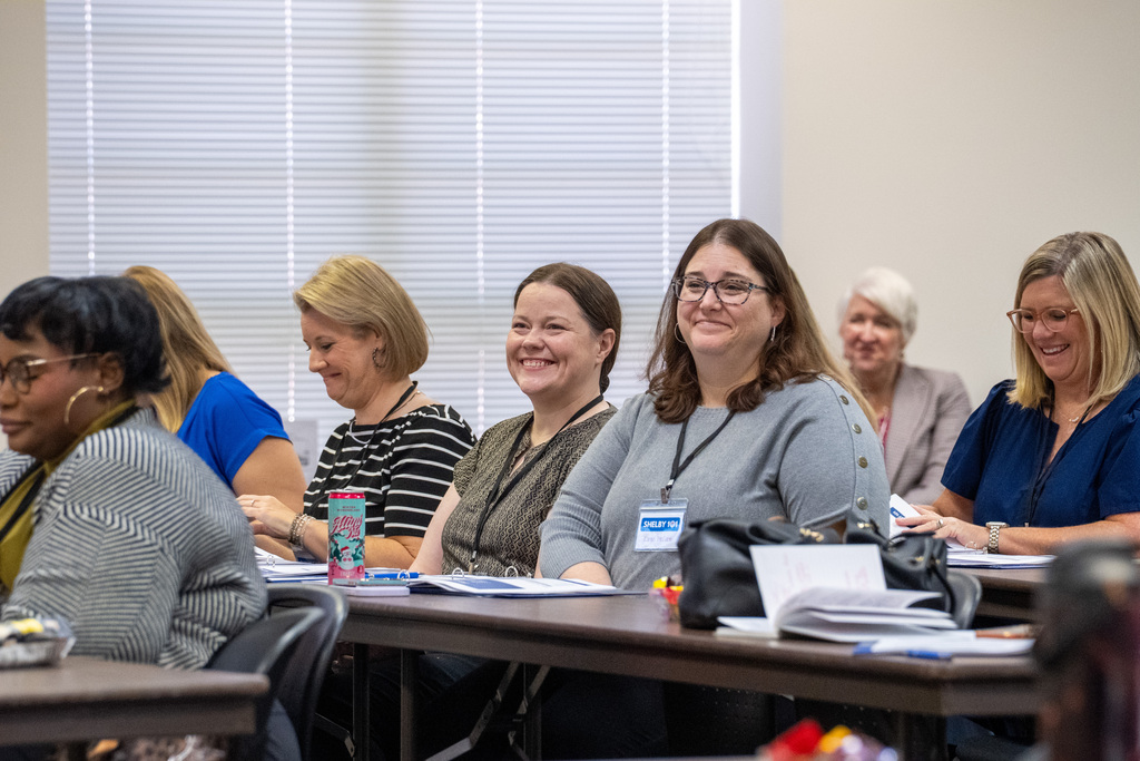 People smiling at a Shelby 101 Meeting