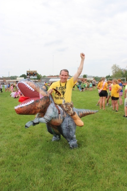 mr tush riding a t-rex