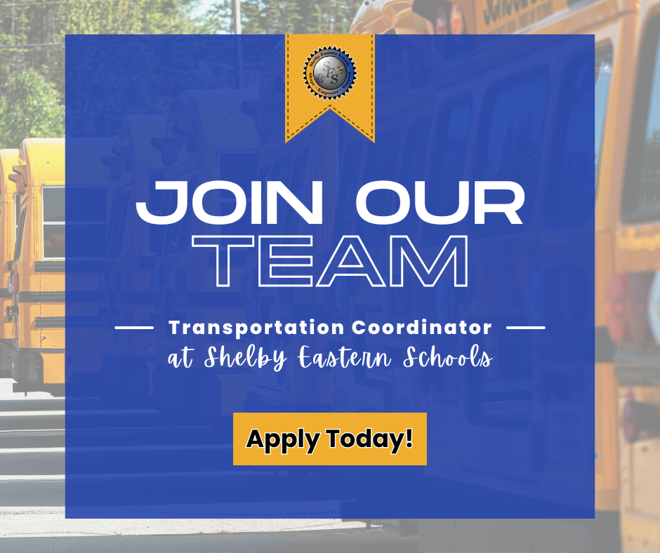 A promotional hiring graphic for Shelby Eastern Schools features a solid blue square overlaying a blurred background of yellow school buses parked in a row. At the top center of the blue square is a yellow ribbon banner containing the school district's circular logo. Large, stylized white text in the center reads "JOIN OUR TEAM," followed by "Transportation Coordinator at Shelby Eastern Schools" written in smaller, decorative white fonts. At the bottom, a solid yellow rectangular button contains the black text "Apply Today!".