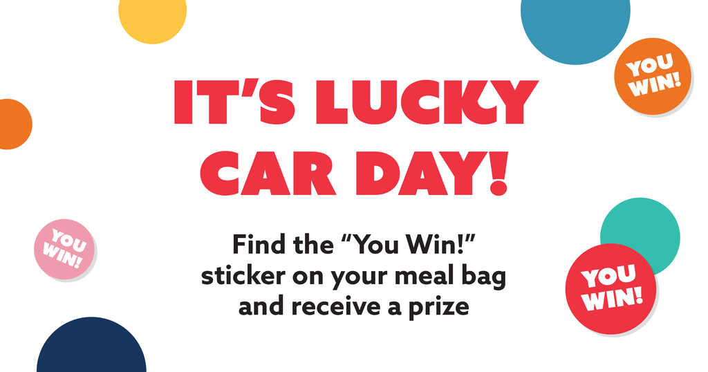 An promotional graphic with a white background featuring colorful dots and text.  At the top and bottom are scattered, solid-colored circles in yellow, orange, dark blue, light blue, and teal. Three of these circles—one pink on the left, one orange on the top right, and one red on the bottom right—are styled as stickers slightly tilted with the white text "YOU WIN!" inside them.  In the center, large, bold red capital letters read: "IT'S LUCKY CAR DAY!"  Below this headline, smaller black text reads: "Find the “You Win!” sticker on your meal bag and receive a prize"