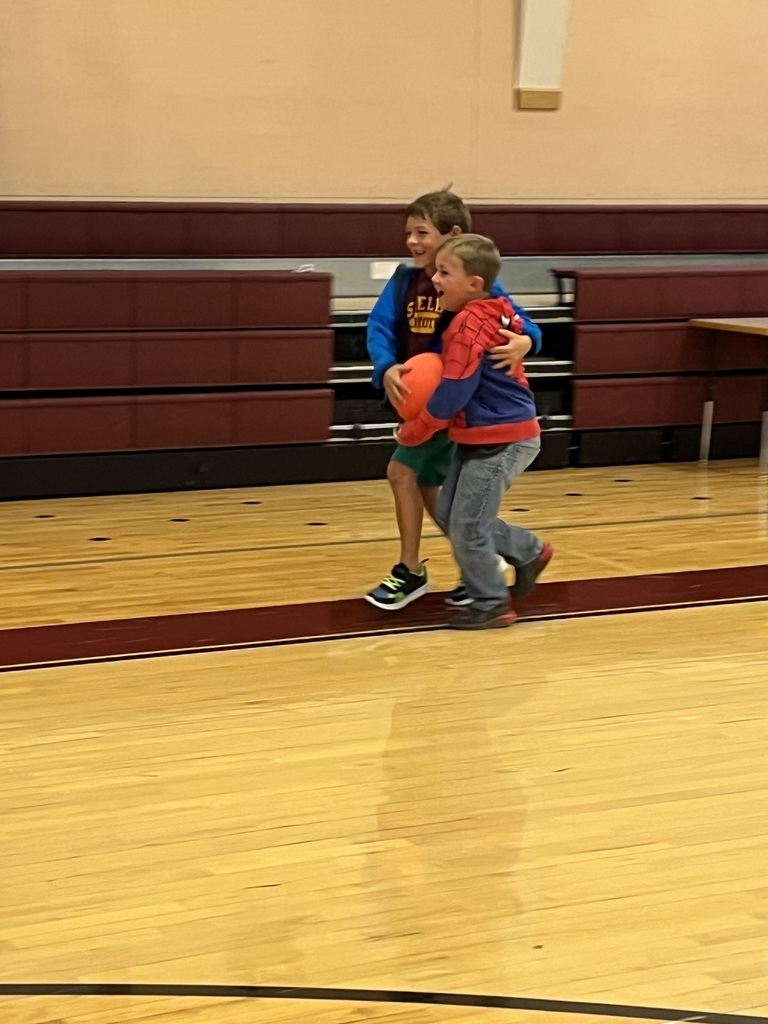 boys balancing ball between them