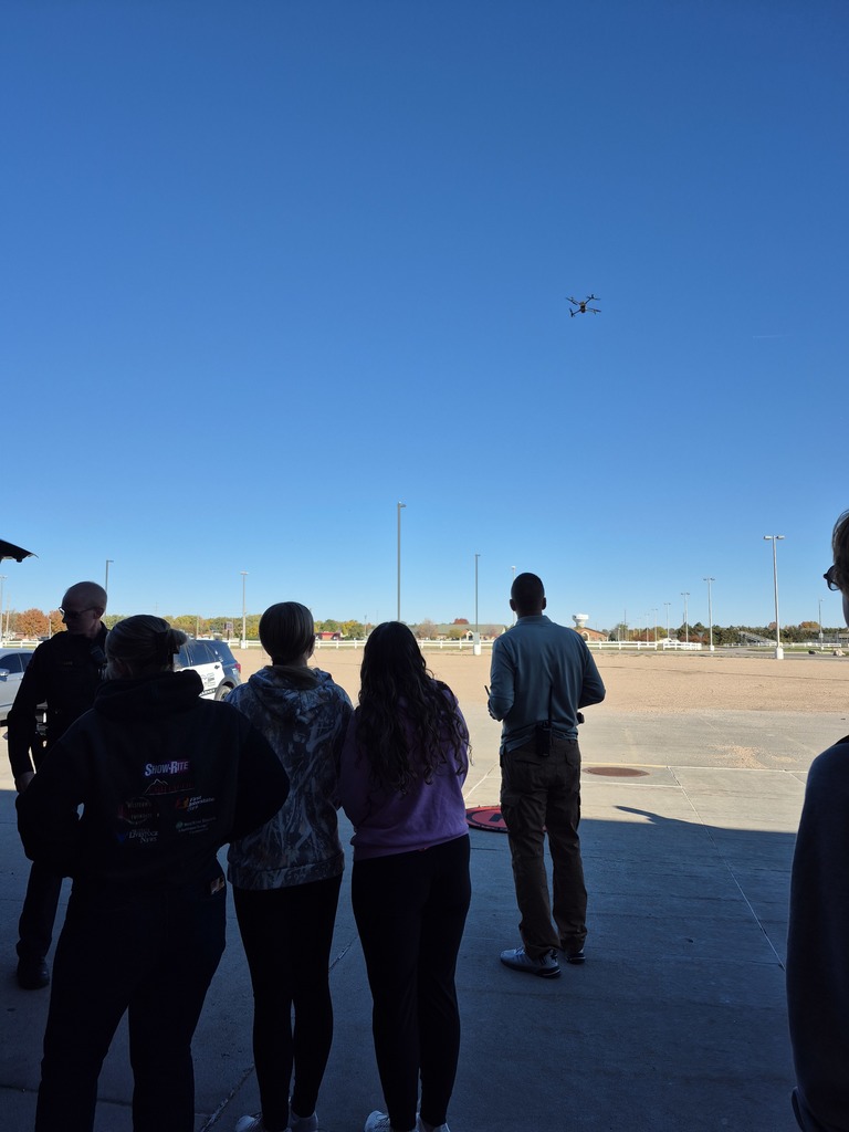 Students observing a drone flying for the forensic science station