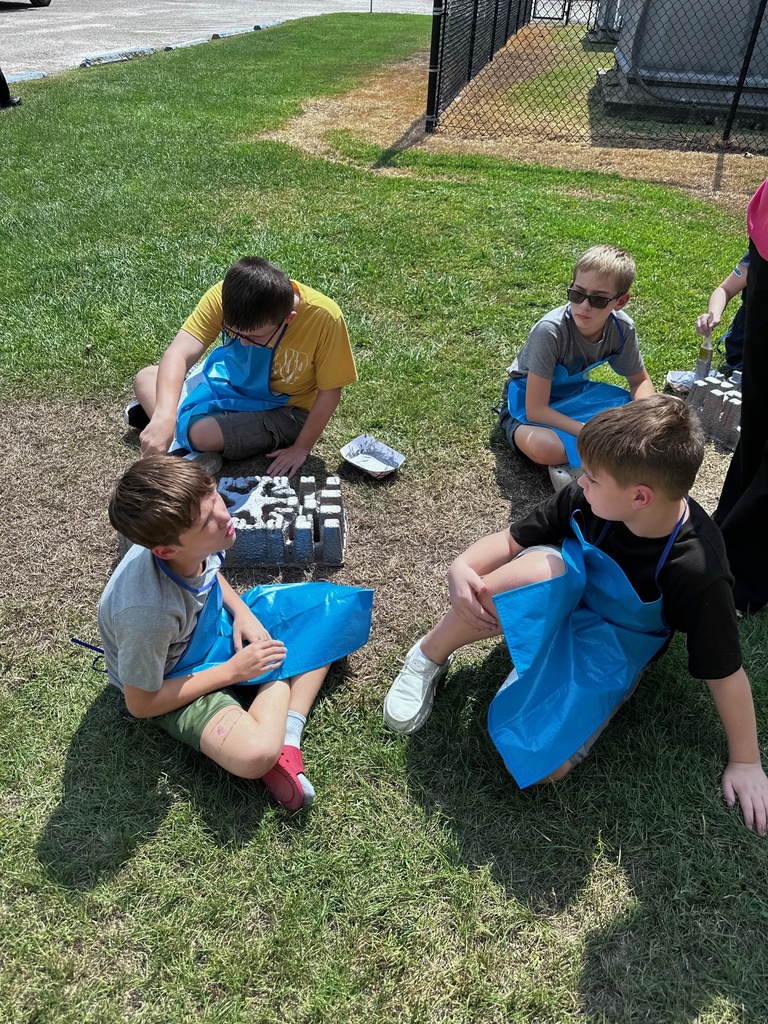 students  outdoors being creative