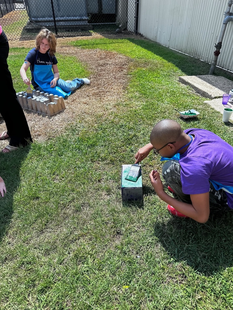students  outdoors being creative