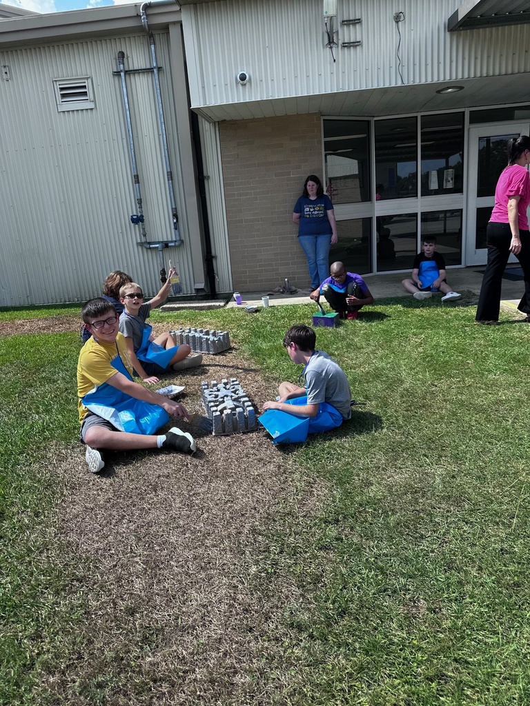 students  outdoors being creative