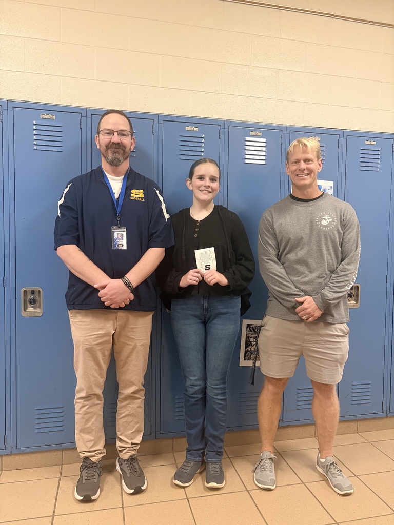 Photo of Alexis Grove with two staff members following her recognition at SPS' board meeting.