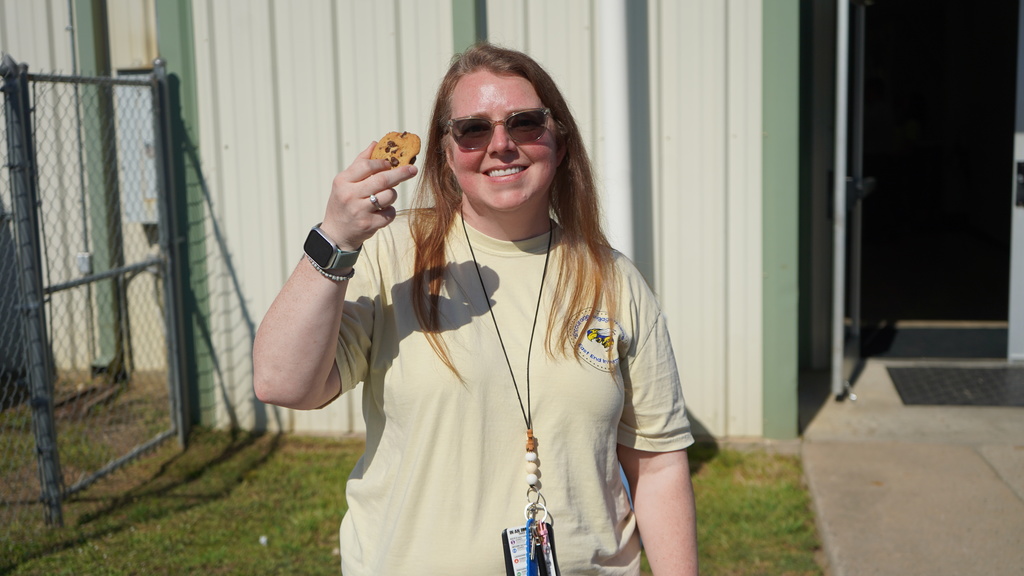 EEI staff member holding cookie