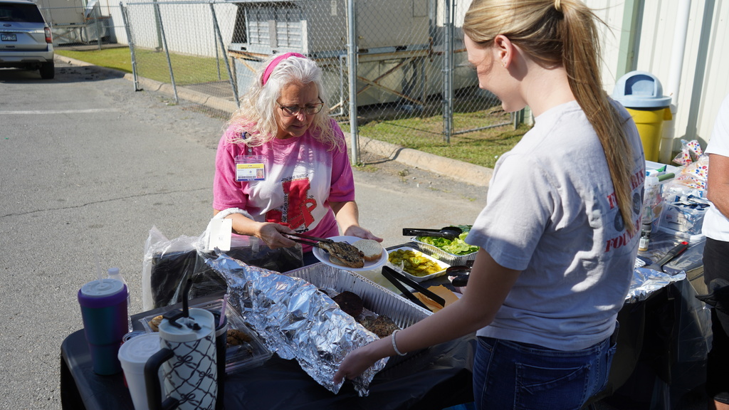 EEI staff member fixes plate of food