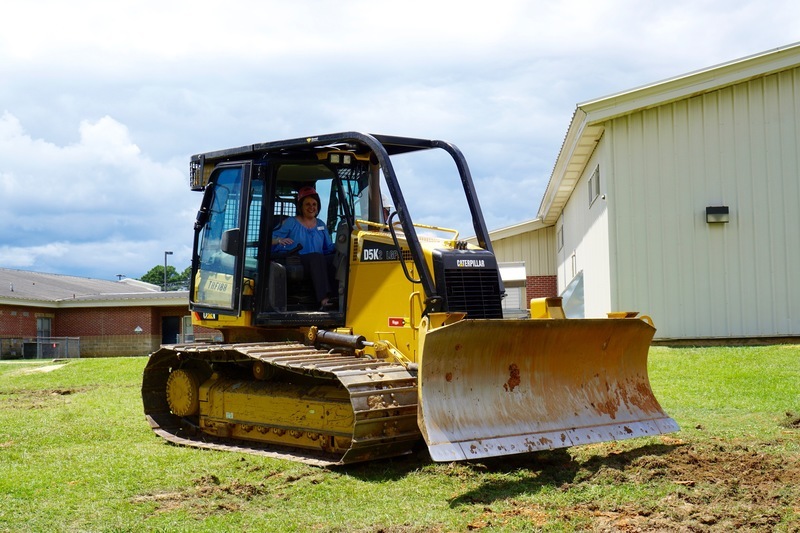 Assistant Principal Teresa Knight operates back hoe at SIS groundbreaking ceremony Assistant Principal Teresa Knight operates back hoe at SIS groundbreaking ceremony