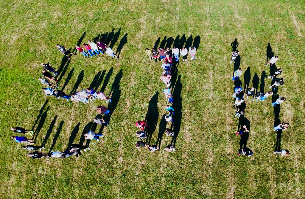 Shiloh Junior High students standing on fieild forming the letters "SJH"