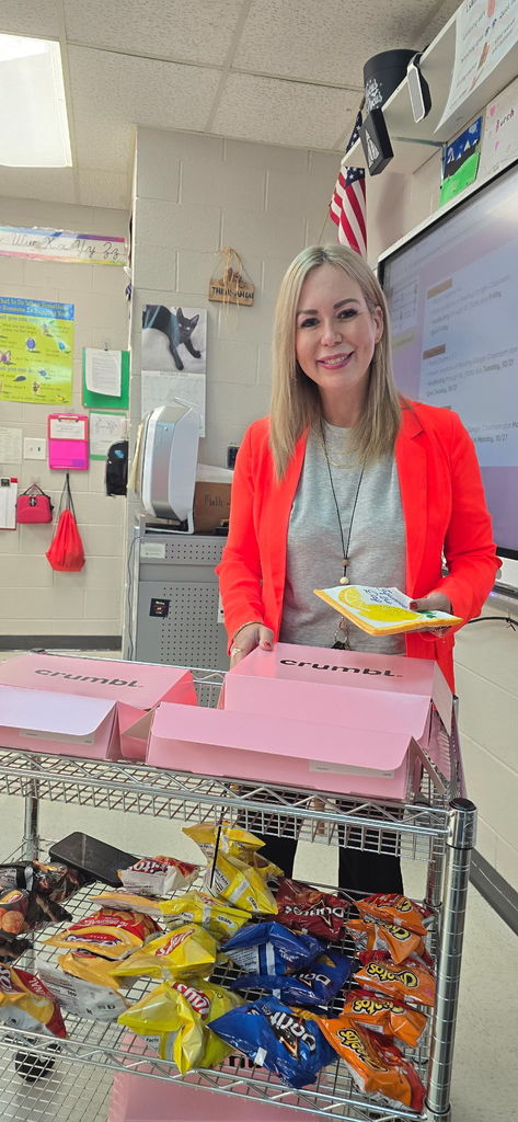 Photo of Ms. Jones with a cart of cookies and chips