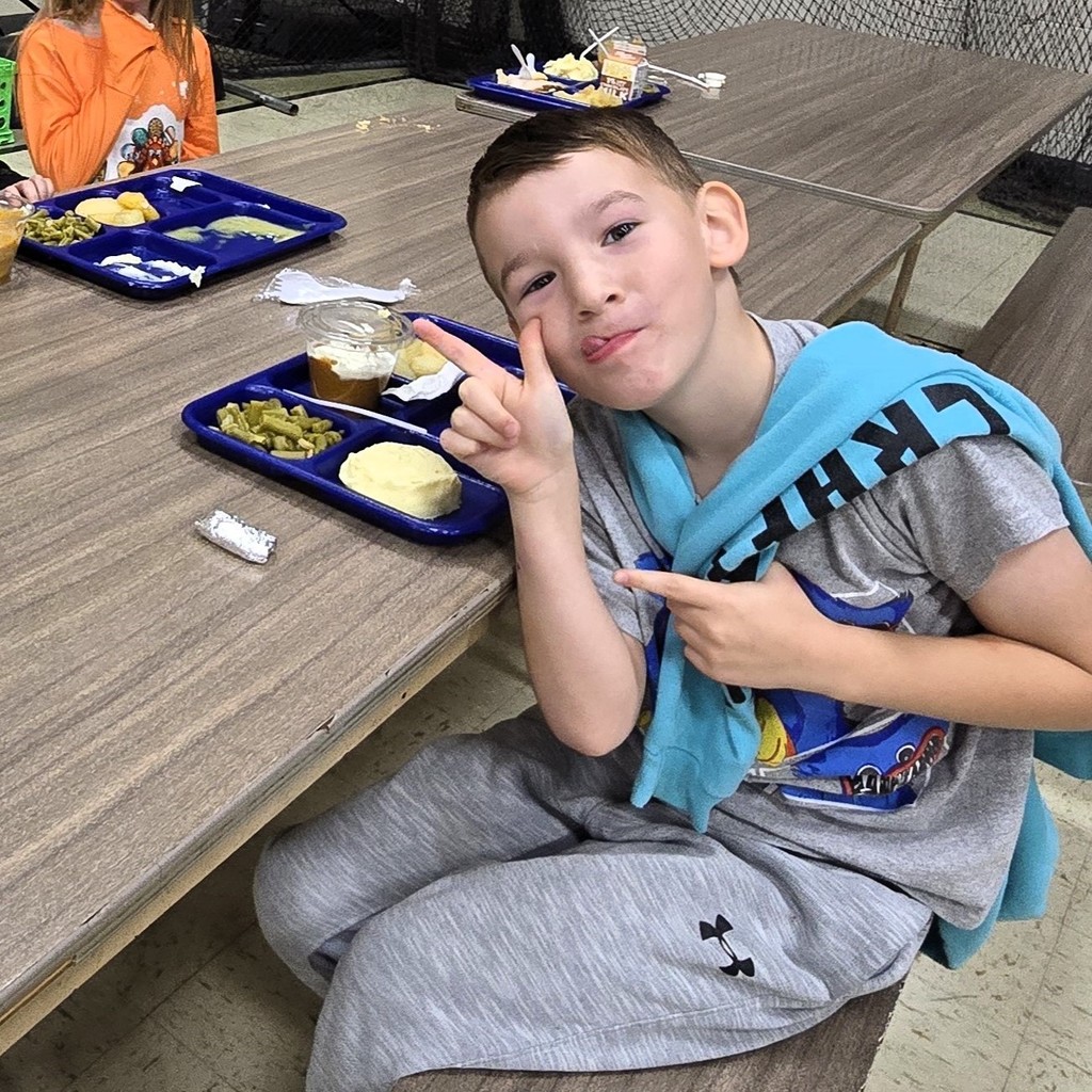 Elementary students in the cafeteria enjoying their Friendsgiving turkey lunch