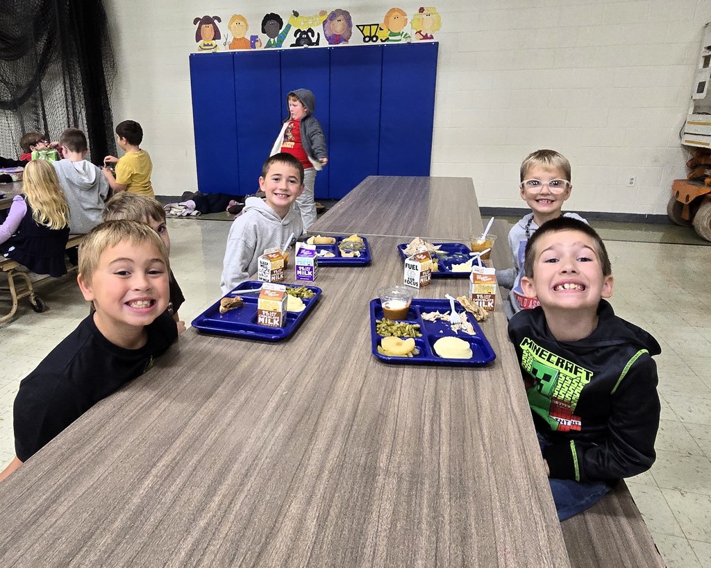 Elementary students in the cafeteria enjoying their Friendsgiving turkey lunch