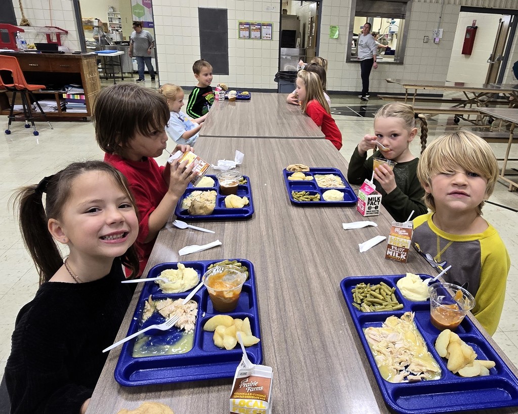 Elementary students in the cafeteria enjoying their Friendsgiving turkey lunch