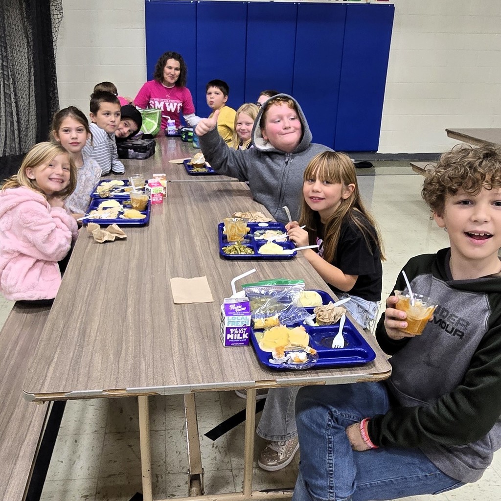 Elementary students in the cafeteria enjoying their Friendsgiving turkey lunch