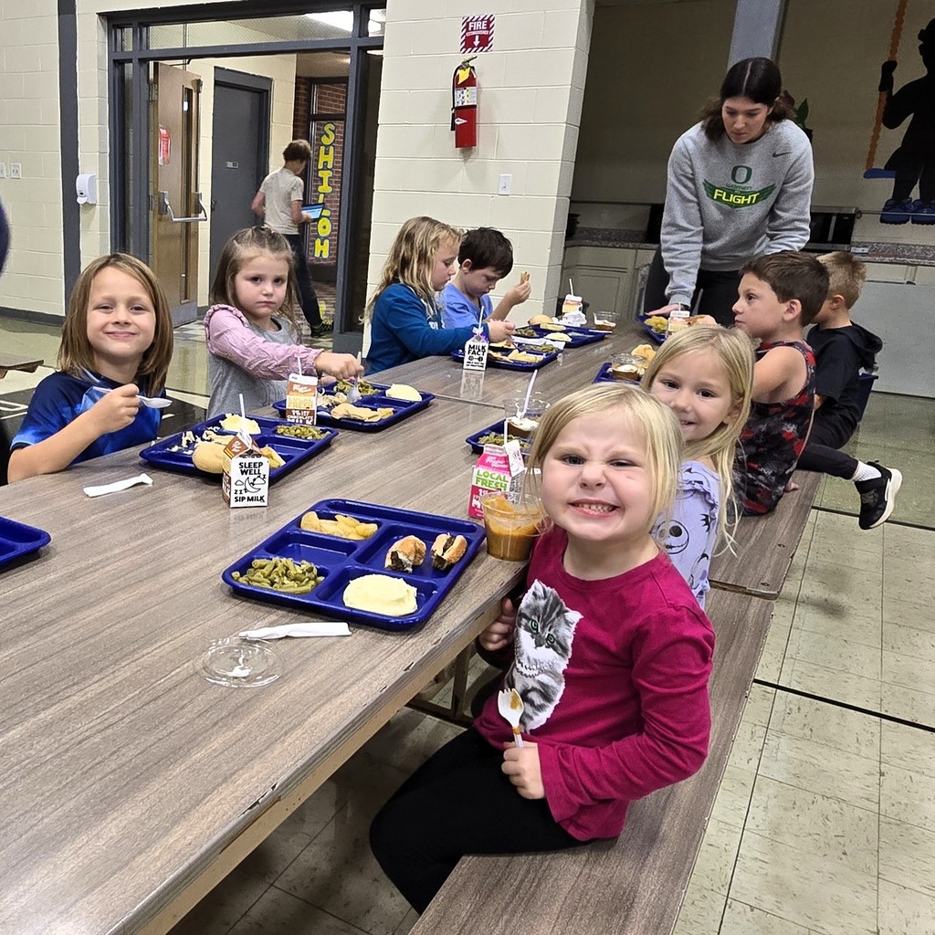 Elementary students in the cafeteria enjoying their Friendsgiving turkey lunch