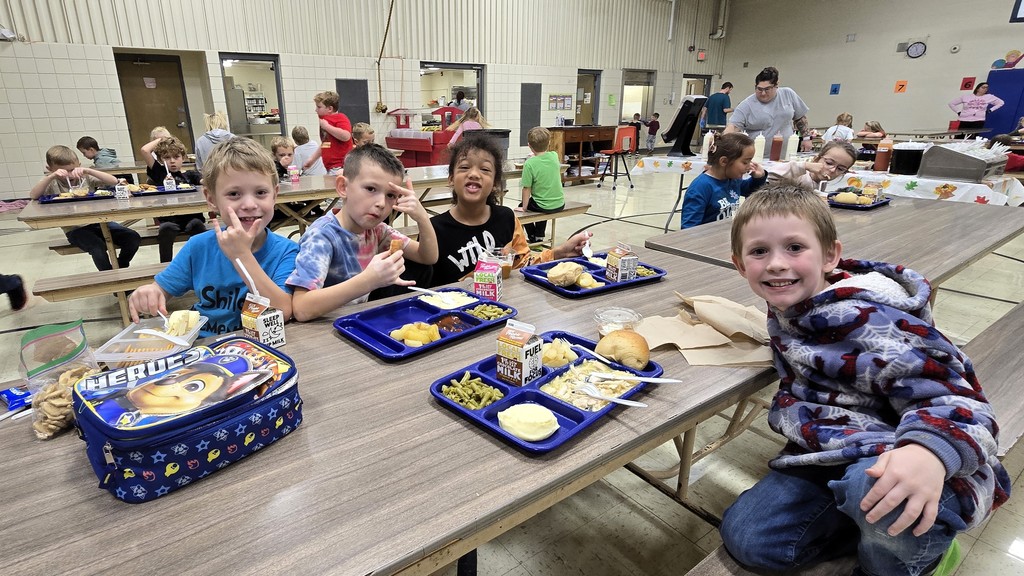 Elementary students in the cafeteria enjoying their Friendsgiving turkey lunch