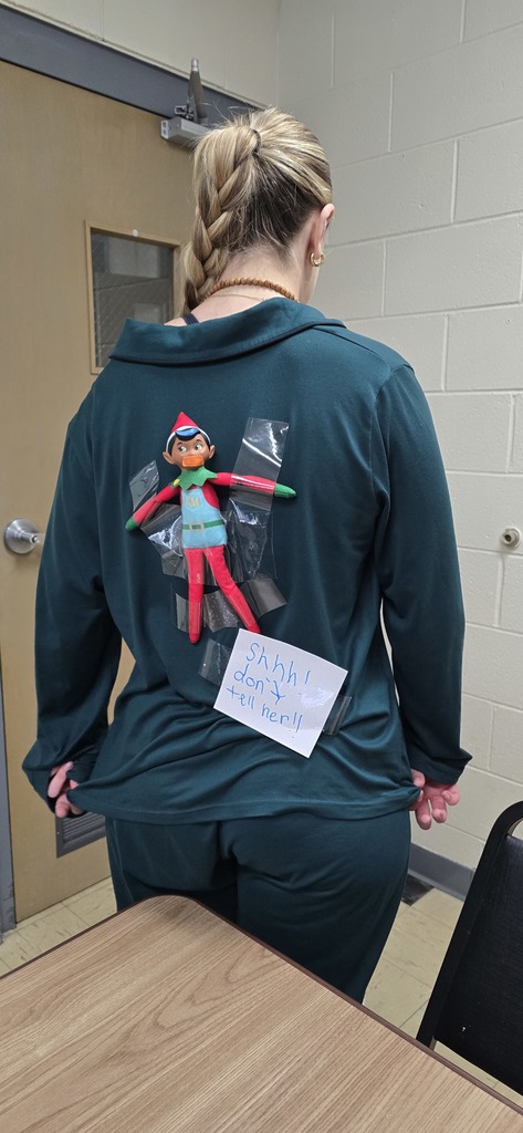 Sneaky elf on teacher's back