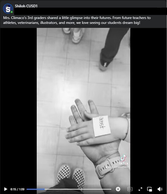 A screenshot of a TikTok posted on the Shiloh Facebook page showing a student's hand with "artist" written on a sticky note stuck on the top of the hand while they give their teacher 5
