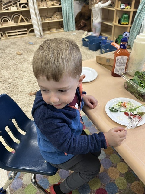 Picture of prekindergarten students eating their vegetables just like plant-eating dinosaurs