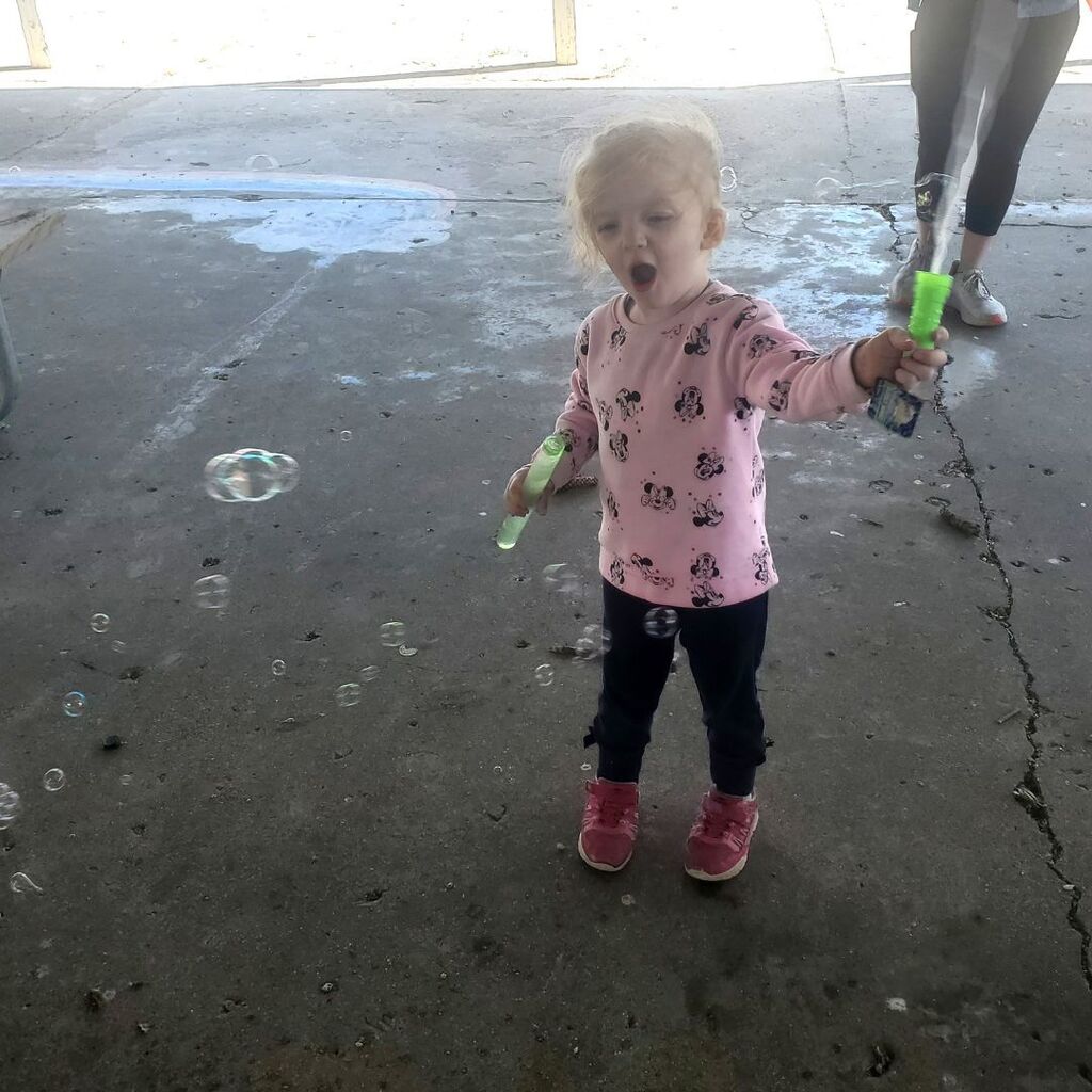 Photos of toddlers and familes on a playground for the May Partnership-in-Parenting group connection