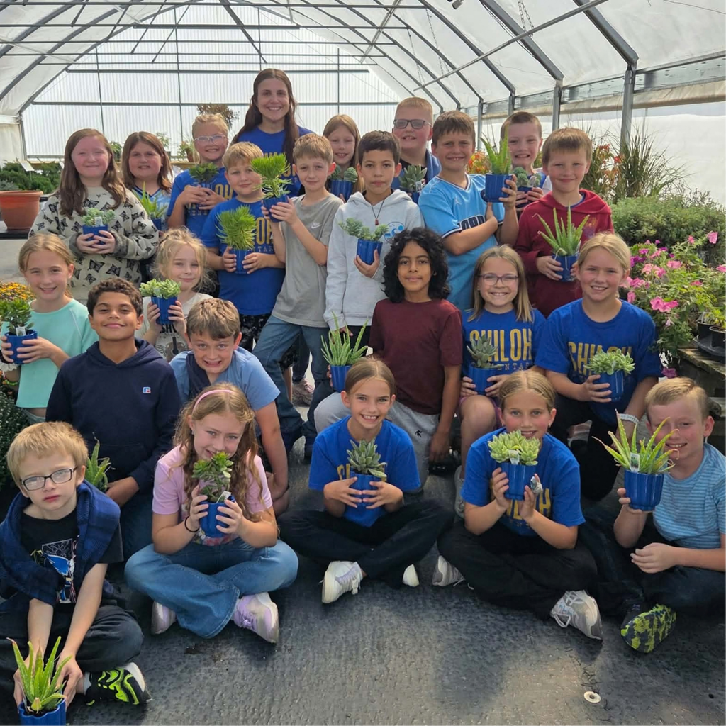 Group picture of the 4th grade class holding succulents from the greenhouse