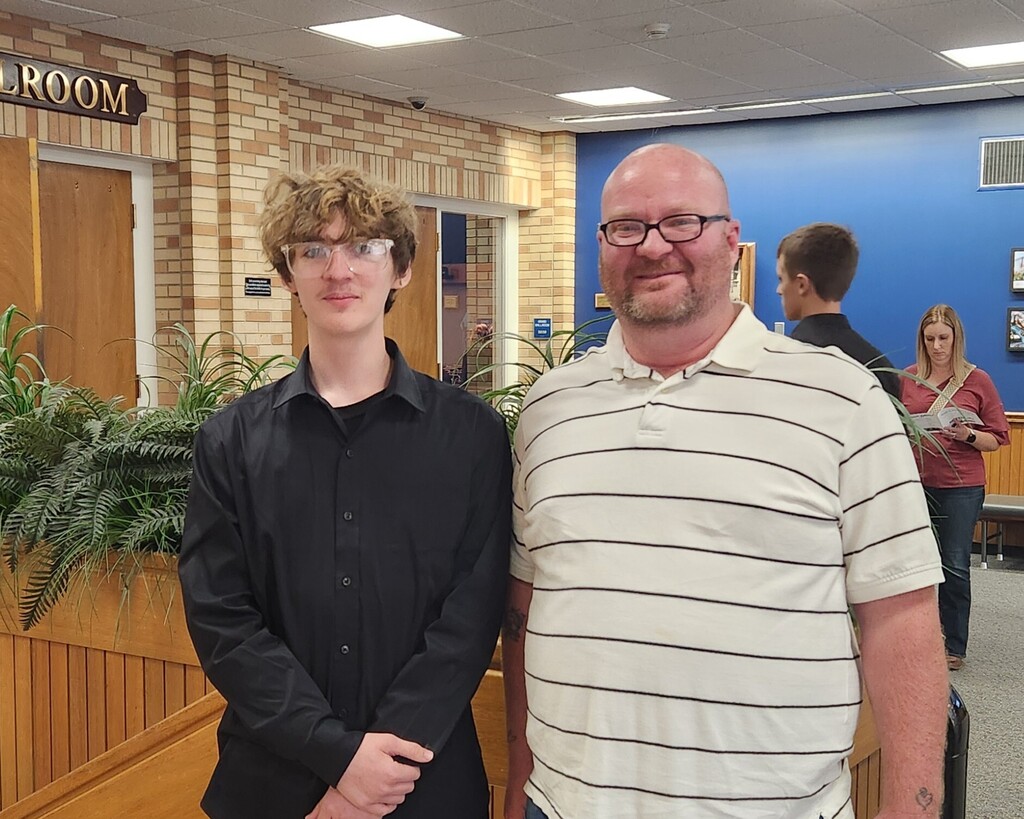 A photo of Joe Elliott standing next to his dad outside of the ballroom at Eastern Illinois University