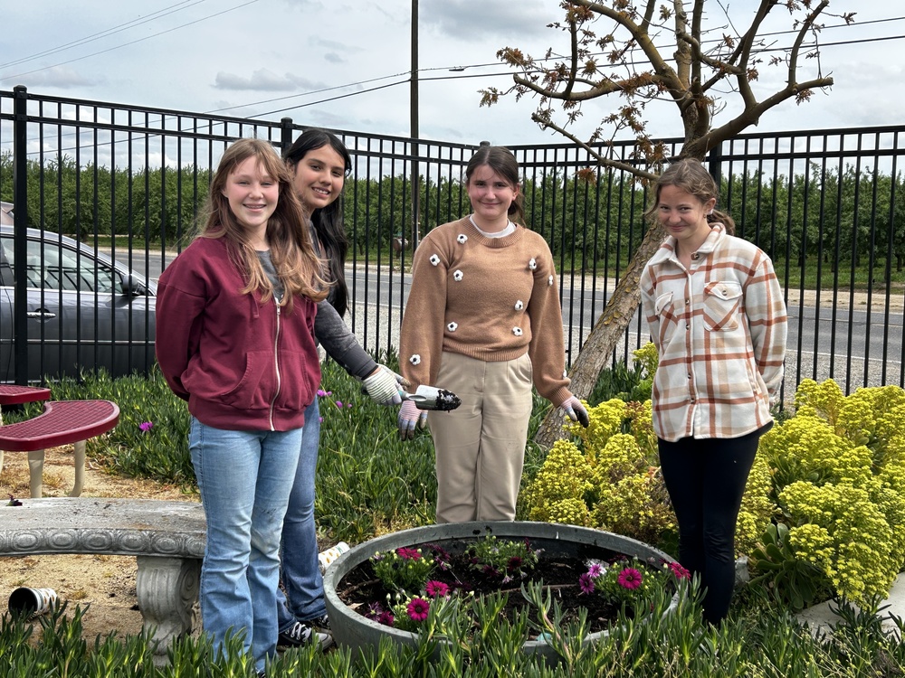 8th graders planting flowers