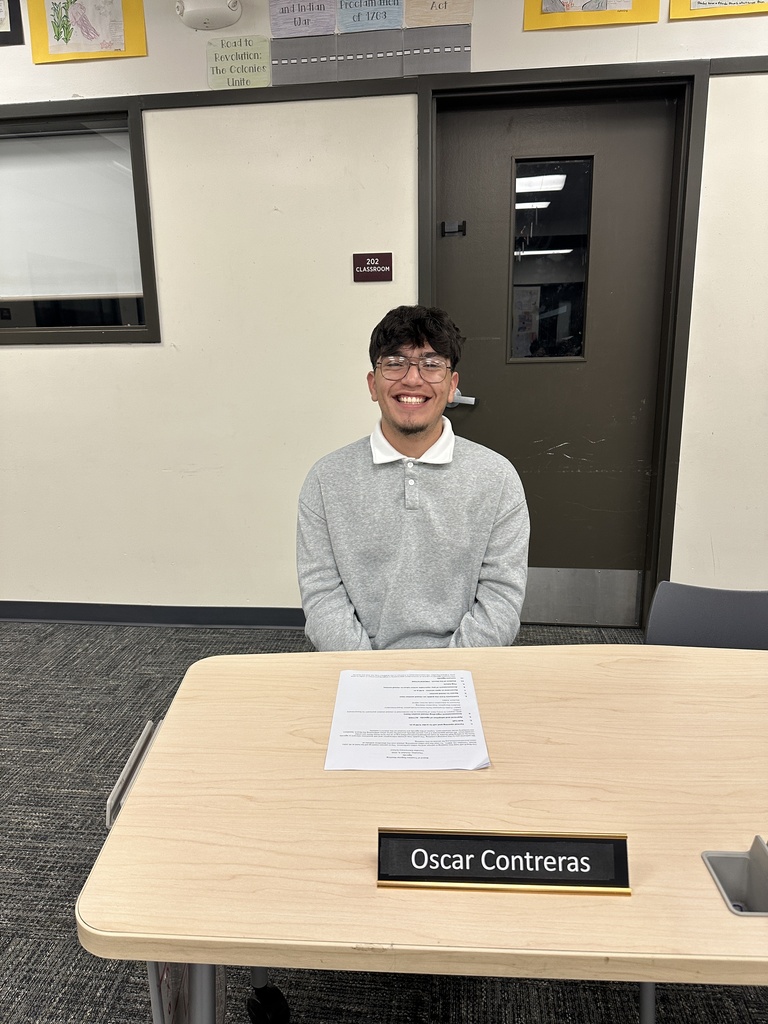 Student board member sitting at desk