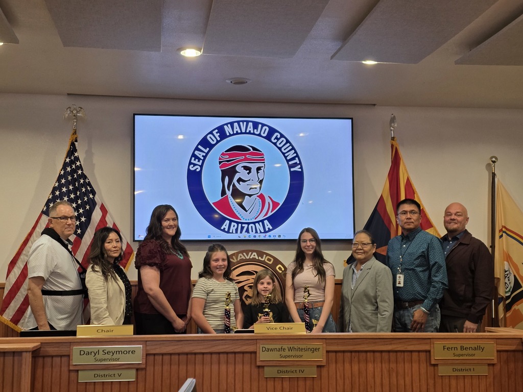 This picture is showing the student that one the award with other members of the family and people from Navajo County