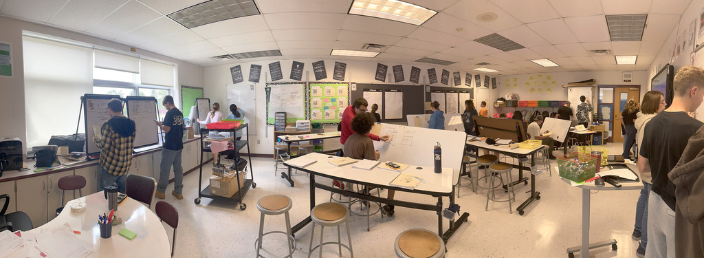 Students in Algebra 1 using white board to work on problems
