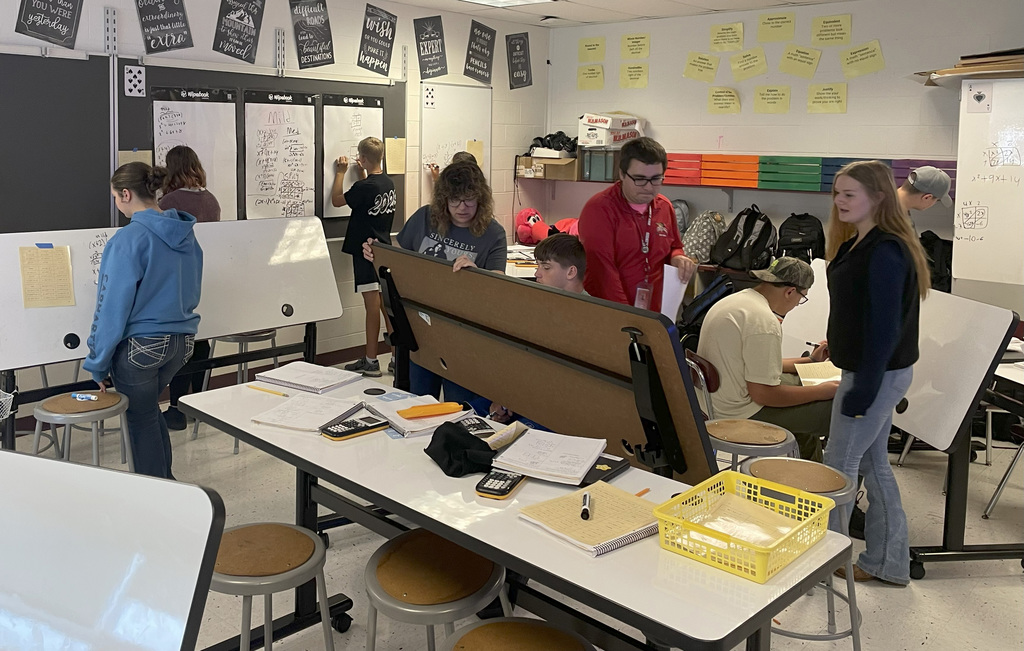 Students in Algebra 1 using white board to work on problems