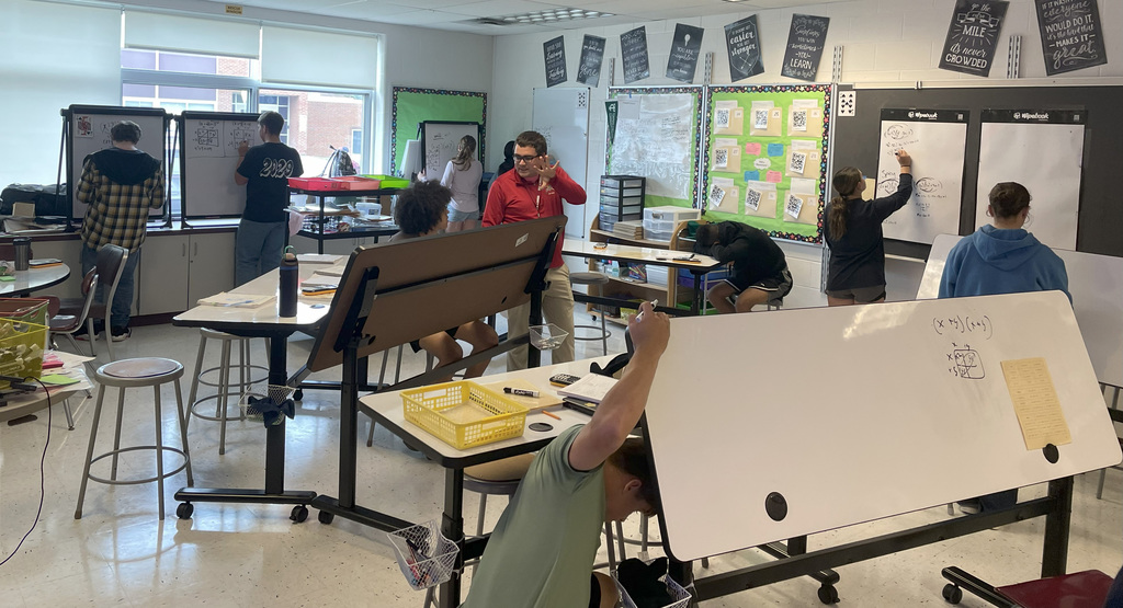 Students in Algebra 1 using white board to work on problems