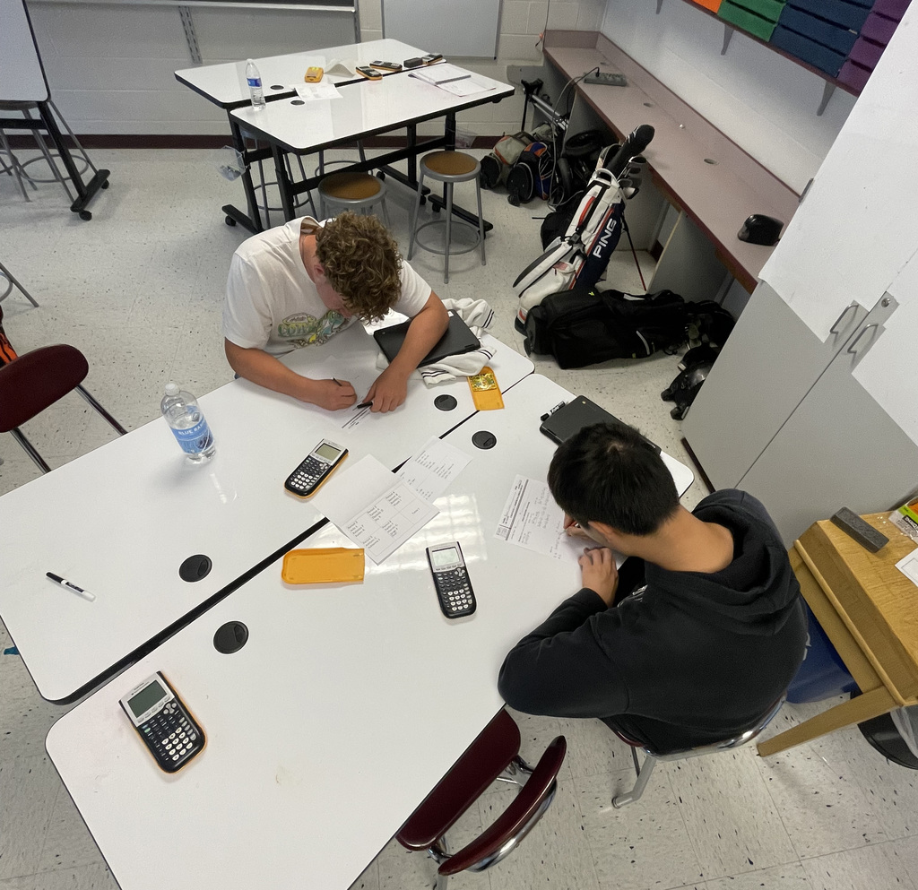Students in Algebra 1 using white board to work on problems