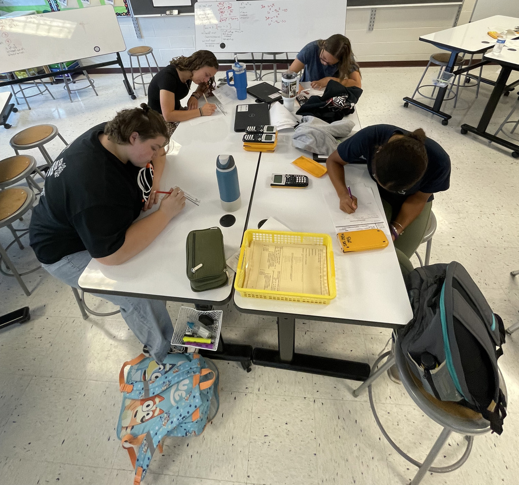 Students in Algebra 1 using white board to work on problems