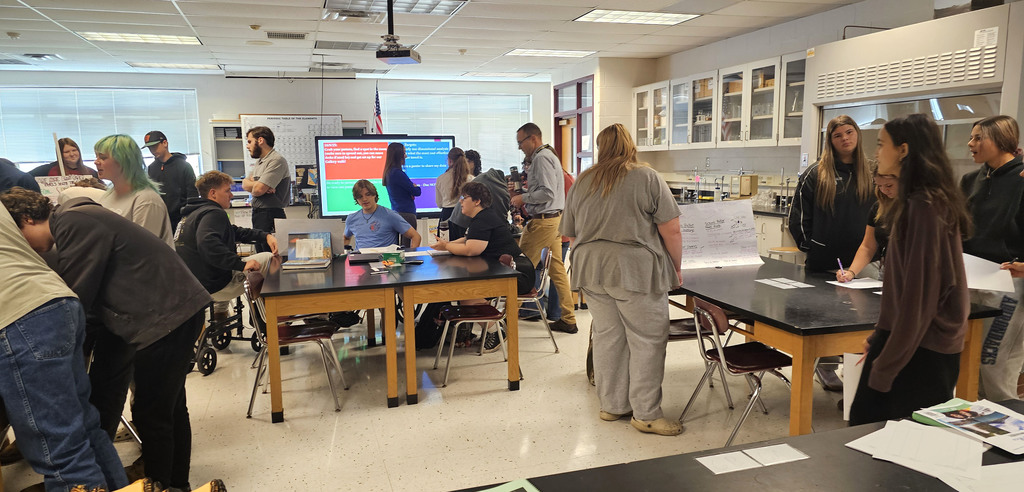 Students showing off their findings in physical science class.