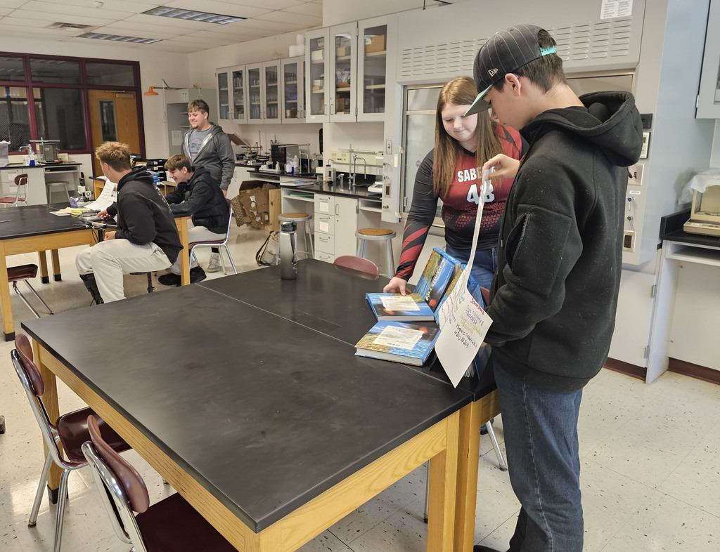 Students showing off their findings in physical science class.