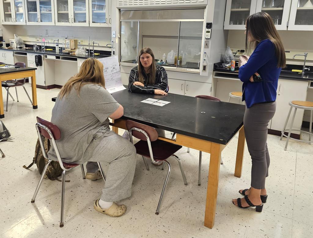 Students showing off their findings in physical science class.
