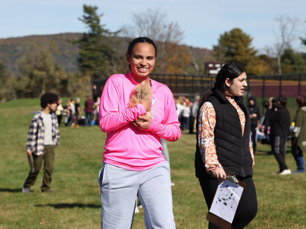 Students interacting with others and animals at the FFA Fair. 